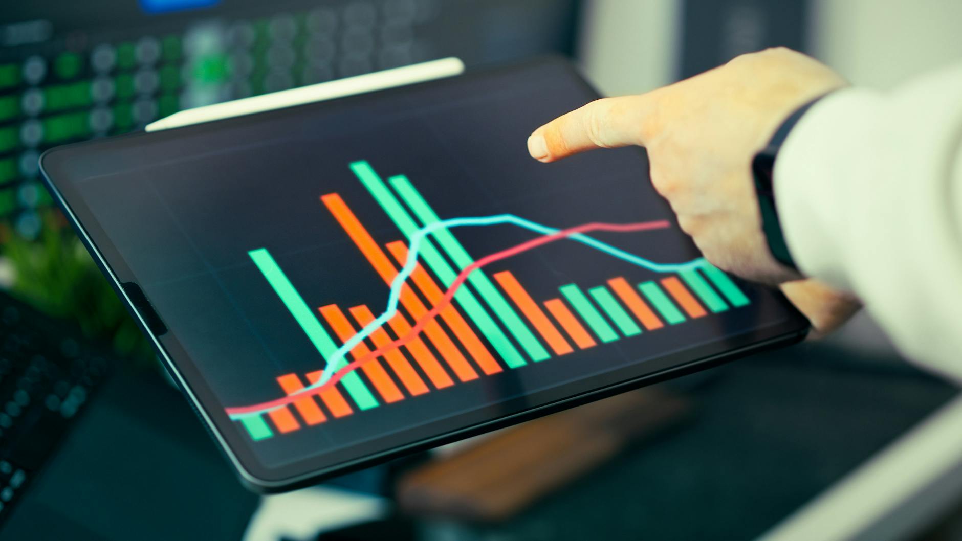 business analysis on tablet with graphs and charts